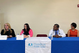 group panel sitting at table with Hamilton Health Center banner