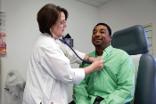 physician checking patient with stethoscope