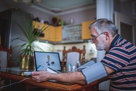 older adult male at computer