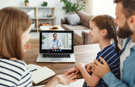 Family using telehealth to talk with doctor on computer
