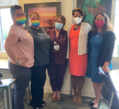 DASPA and four grantee staff posing indoors and wearing masks