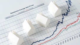 Image of a house on top of a line graph.