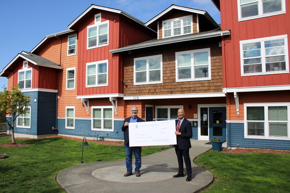 Two men standing in front of apartments