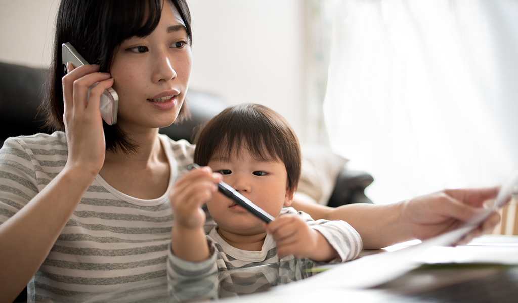 Mother with child at work