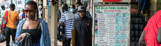 woman passing by currency exchange store