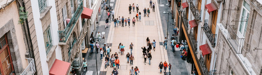 overhead image of people walking down busy shopping street