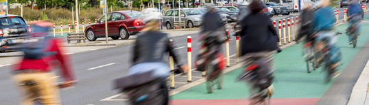 photo of cyclists on bike lane in motion blur