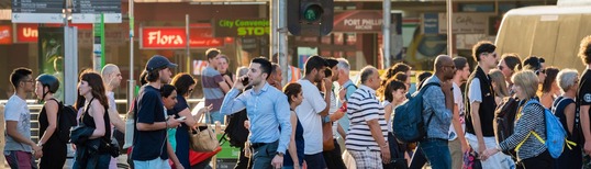 image of people walking across street in a busy city