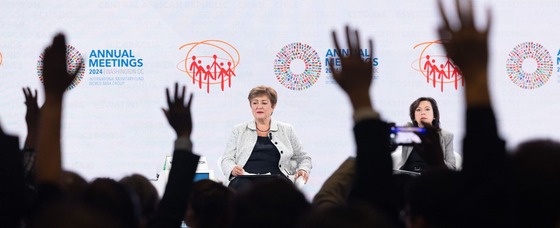 photo of IMF Managing Director in a crowd of raised hands