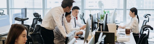 image of Asian people working in an office environment with computers