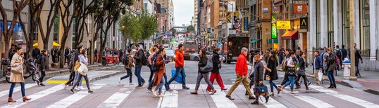 photo of crowd of people crossing a street