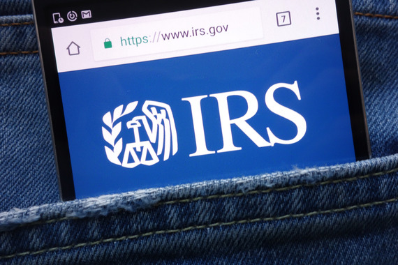 Cellphone in the back pocket of a person displaying www.irs.gov main page