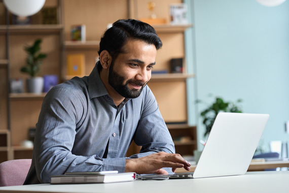 man working on laptop at home office