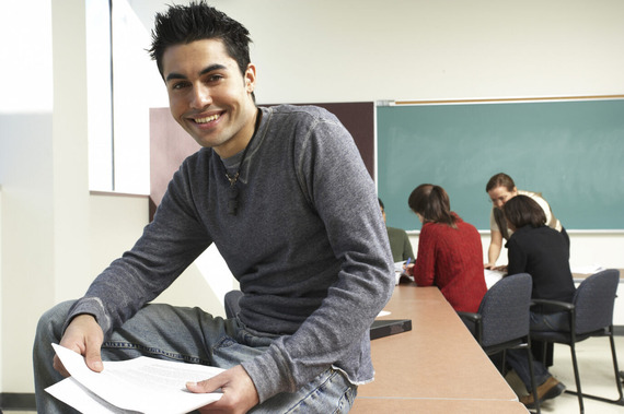 Teacher sitting on a desk