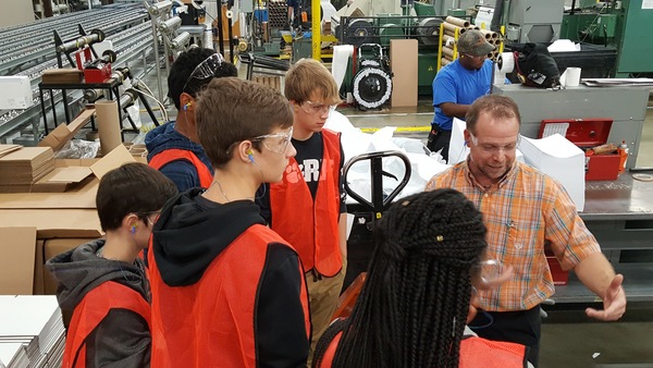 An employee of UK-based manufacturing company Domtar provides high school students with a tour of the company’s facility in Rock Hill, S.C. on Oct. 6.