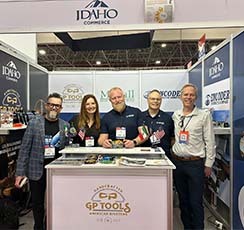 Group of individuals from Encoder standing in a trade show booth