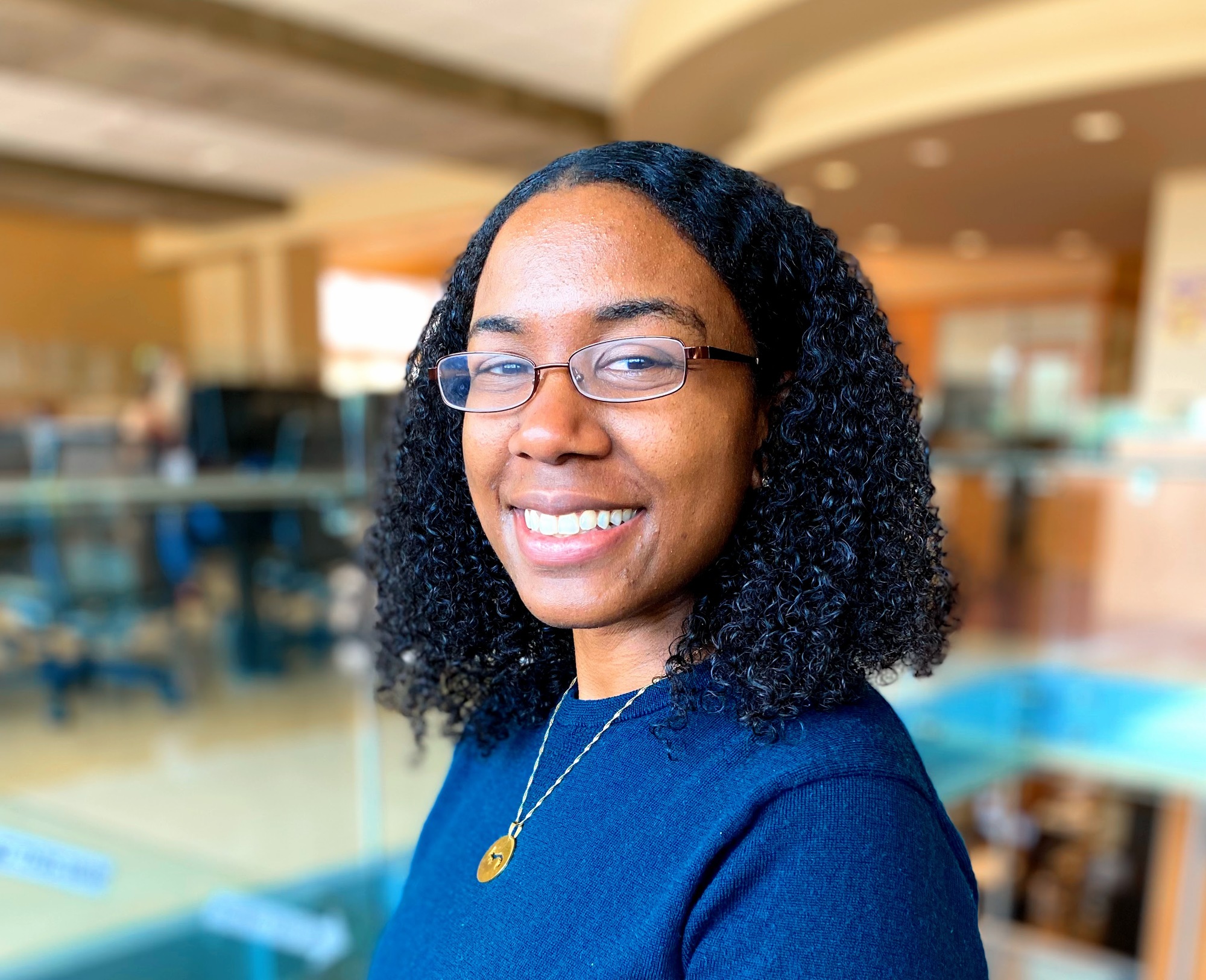 Bree'ya Brown, recipient of the higher education grant on behalf of Huston-Tillotson University, pictured in a library. 