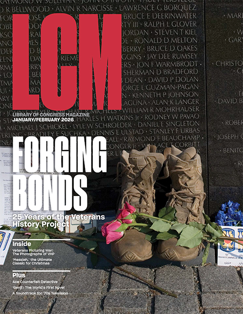 Cover image of the magazine featuring a rose draped over a soldier's boots in front of the Vietnam Memorial wall.