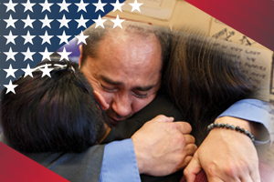 A veteran embraces a Gold Star military family members he interviewed for contributions to the Veterans History Project