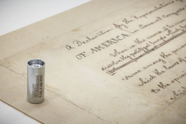 Synthetic DNA scaled next to Thomas Jefferson's Draft of the Declaration of Independence