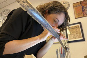 Technician Courtney Holschuh inspects the 35 mm nitrate negative of Gugusse and the Automaton stretched between two reels. Photo by Shawn Miller