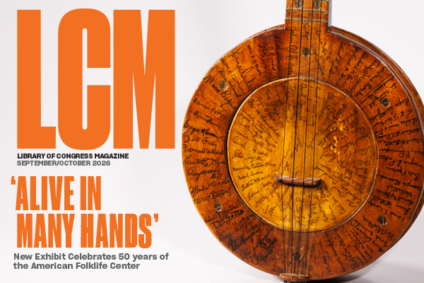 A close up of a wooden banjo covered with signatures of prominent folk musicians and scholars. Photo by Shawn Miller