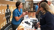 woman talking to others at health fair 