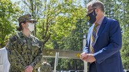 McCaffery presents a personal coin to service member