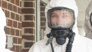 Airman Faith Coffelt decontaminates her chemical suit