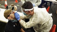 medical person swabbing nose of patient