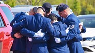 service members huddled in grief