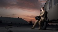 servicewoman leaning against helicopter