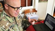 service member at desk working