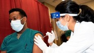 CAPT Horton, an internal medicine provider at Walter Reed, receives a COVID-19 vaccination.