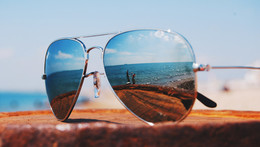 sunglasses on a table at the beach