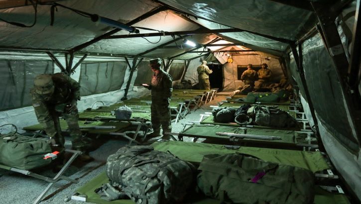 Pic of service members using their bed or cot only for sleeping.