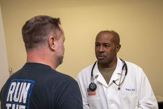 A male patient speaks with a doctor