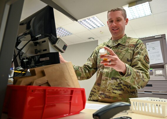 U.S. Air Force pharmacist looks at pill bottle