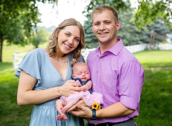 Minnesota National Guard member poses with her husband and infant daughter