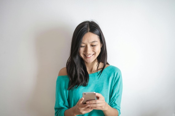 Woman checks her phone. (Courtesy photo from Pexels.com)
