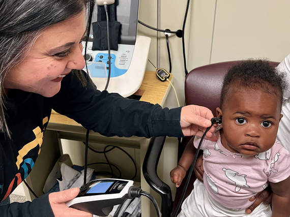 Doctor checks a baby's hearing