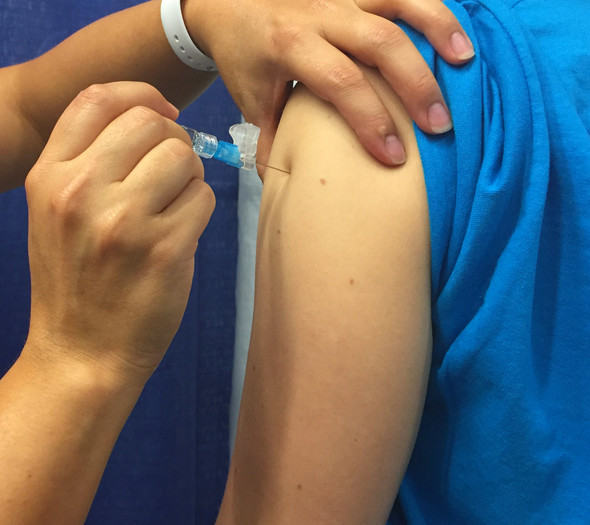 A person receives a seasonal influenza vaccine