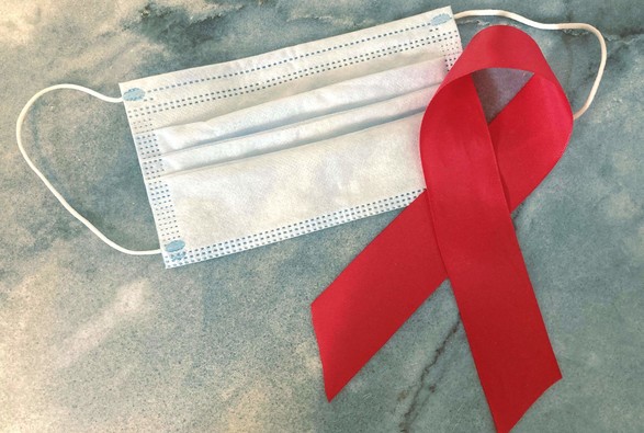 A surgical mask and an HIV/AIDS awareness ribbon. 