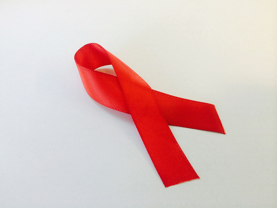 A folded red ribbon against a white background.