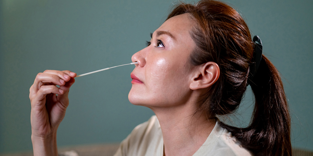 Image of a woman using a nasal swab