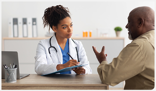 A general practitioner speaking with a patient.