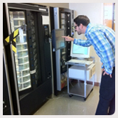 A person selects food from a vending machine