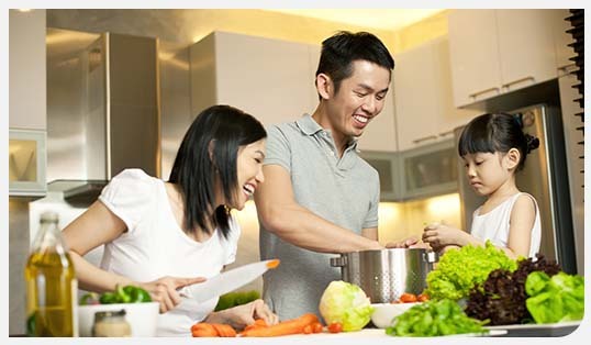 A family preparing a meal in their kitchen