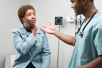 Woman talking to doctor