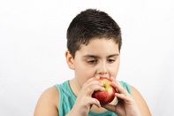 image of child biting an apple